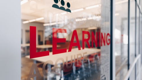 The words Learning Center printed on a window at the learning center space in New Brunswick