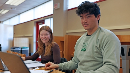 Two students study at a desk in the Learning Centers.