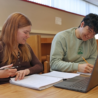 Two students study at a desk in the Learning Centers.