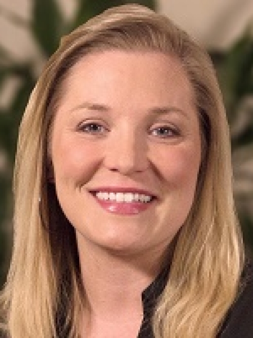 Stacey Blackwell has blonde hair and is wearing a black shirt