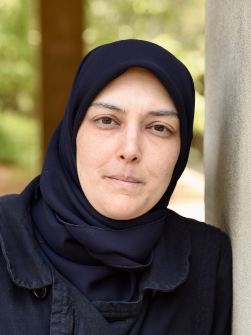 Hebbah El-Moslimany leans against a wall outside the Learning Centers